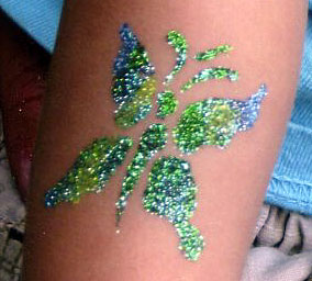 Blue and green glitter butterfly tattoo on arm
