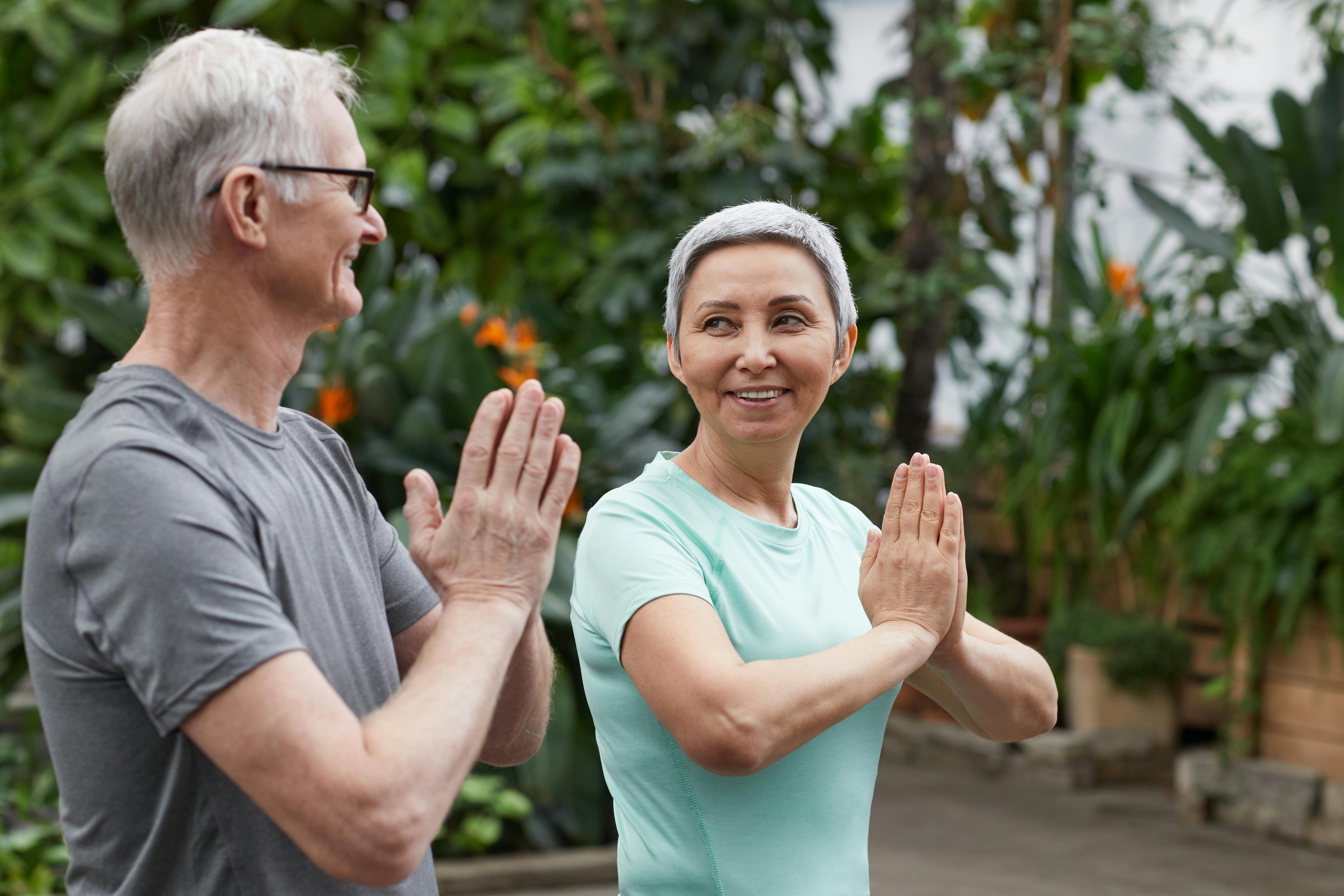Two Older Adults practice Qi Gong