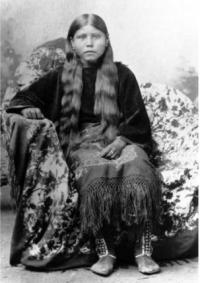 photo: Comanche woman, only identified as wife of Oscar Yellow Wolf only. Traditional dress for women was a blouse and fringed dress, made from buckskin. Western History Collection x-32204