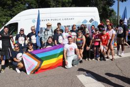 People posing in front of the Denver Public Library bookmobile for the Pride Parade.