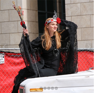 Actor posed on white pickup truck with traditional Shakespearean attire