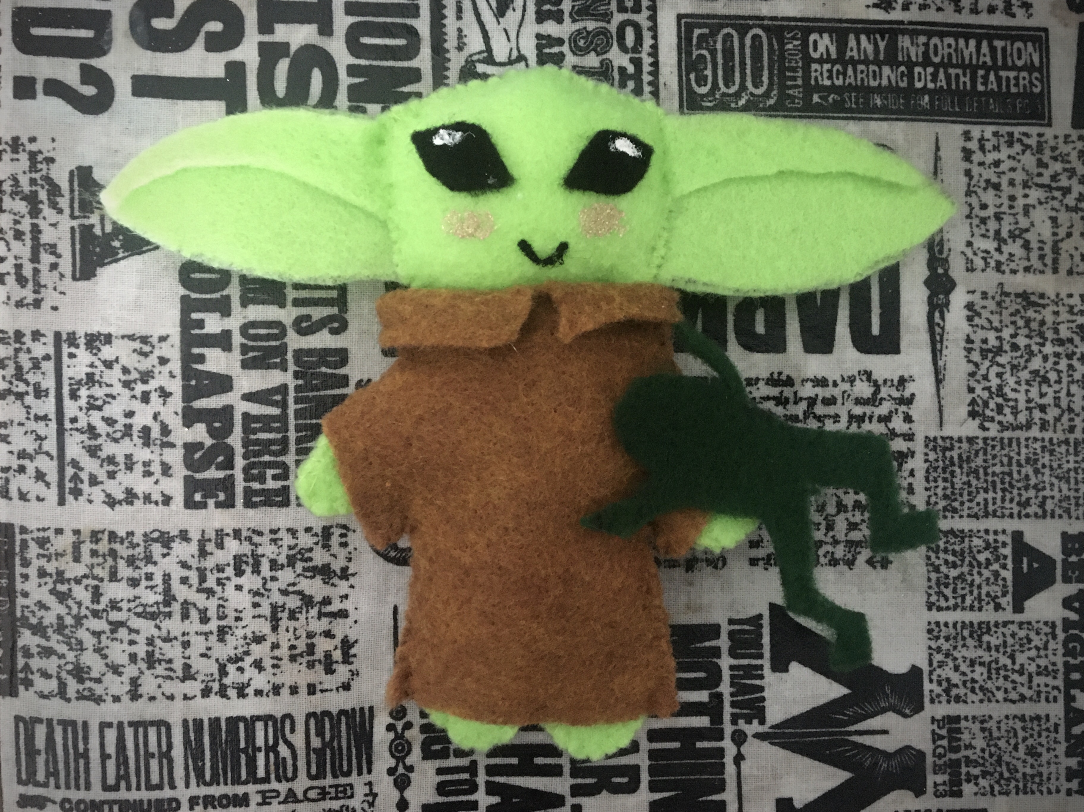 Green alien child plush with brown robe