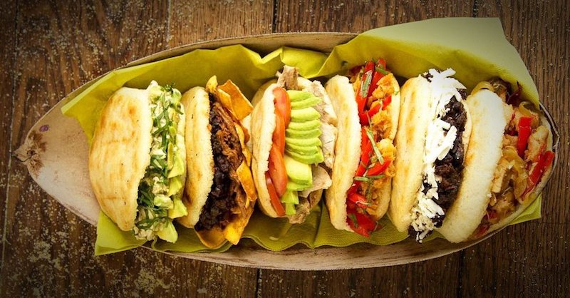 A tray of arepas with various fillings