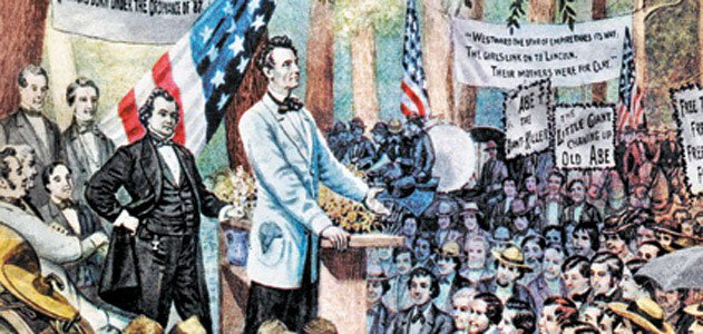 A partially-colored illustration of one of the Lincoln-Douglas debates of 1858. Lincoln stands at a lectern facing the crowd, which is assembled in the open air. Douglas stands behind him. American flags are draped behind the men, and there are signs in the audience.