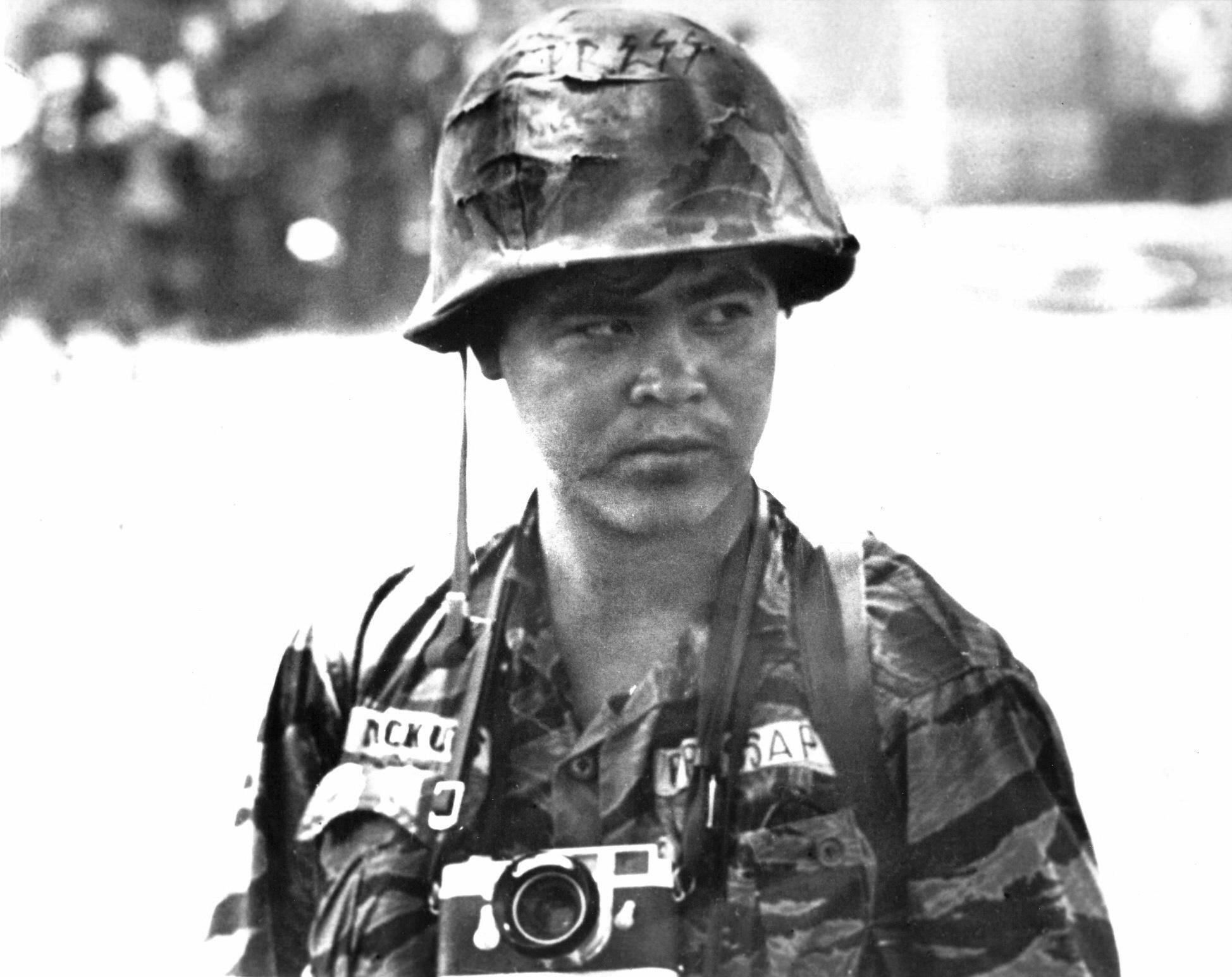 AP photographer Nick Ut in his combat fatigues and a camera around his neck