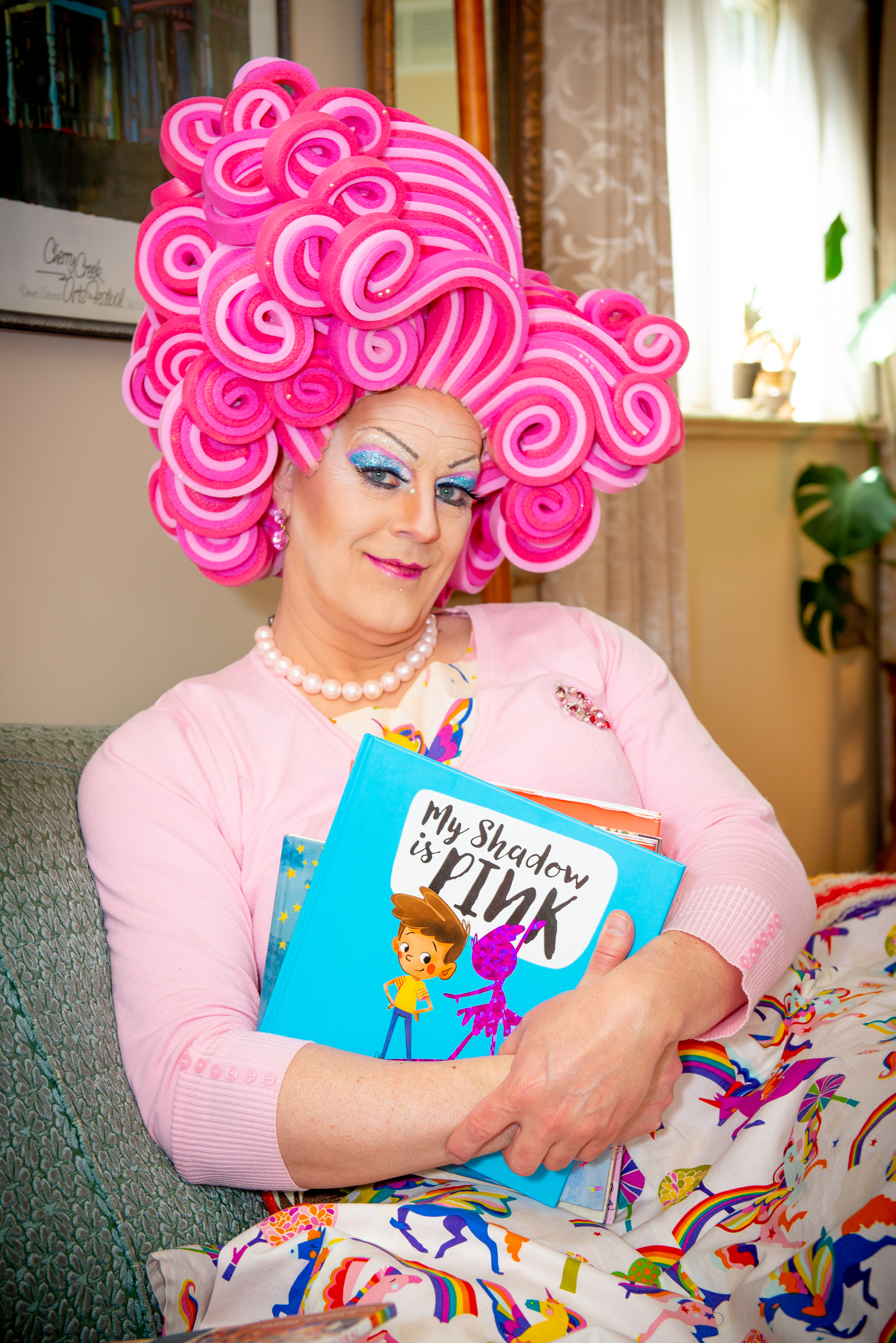 Shirley Delta Blow in pink hair holding a book
