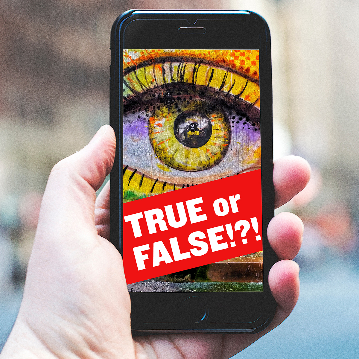 Hand holding smartphone with picture of eye and a banner saying "TRUE or FALSE!?!"