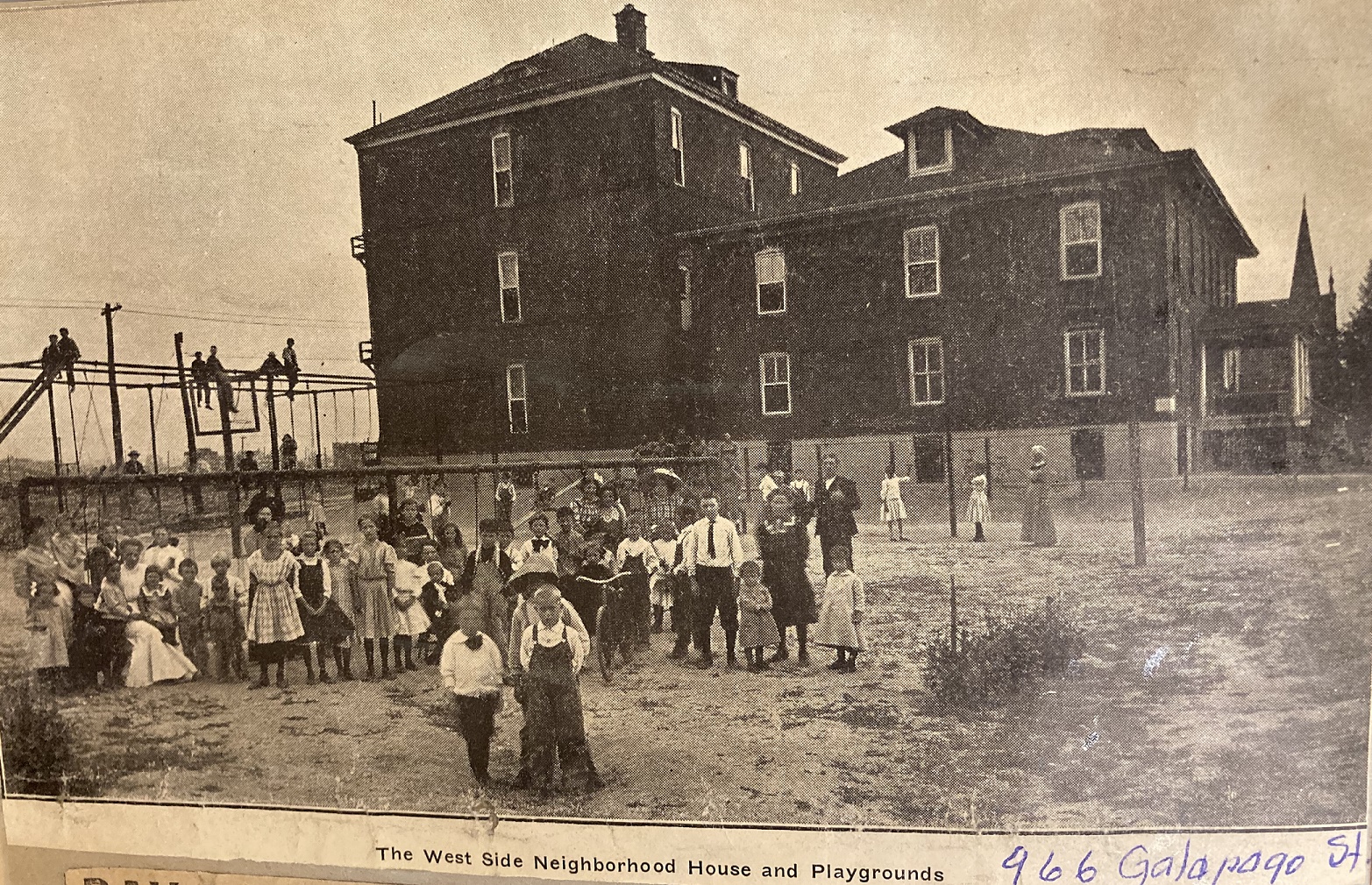 Newspaper clipping image with a large group of children and a few teachers standing in the foreground of a playground. Several children are sitting up high on climbing equipment in the background. Further in the background is a large building. Written on the bottom of the image is "The West Side Neighborhood House and Playgrounds. 966 Galapago Street."