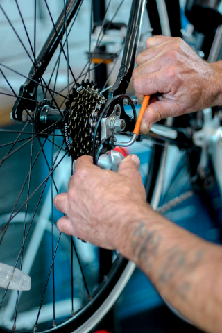 Hands adjusting bicycle wheel
