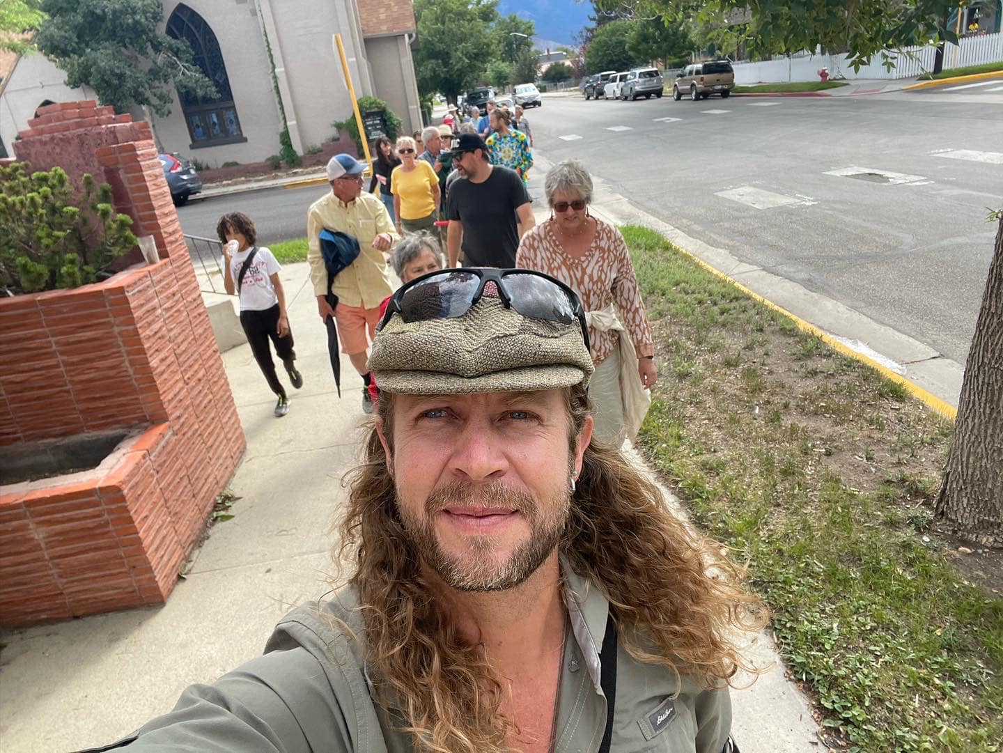 A group of people walking down a sidewalk. 