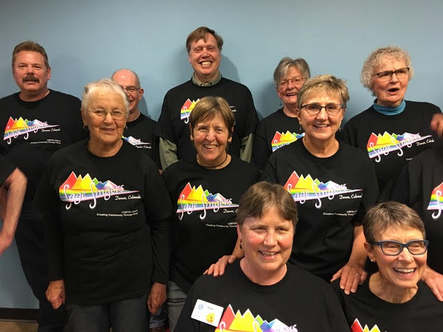 A group of smiling people wearing matching tshirts