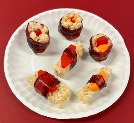 photo of candy sushi made of rice krispy treats, swedish fish and fruit tape
