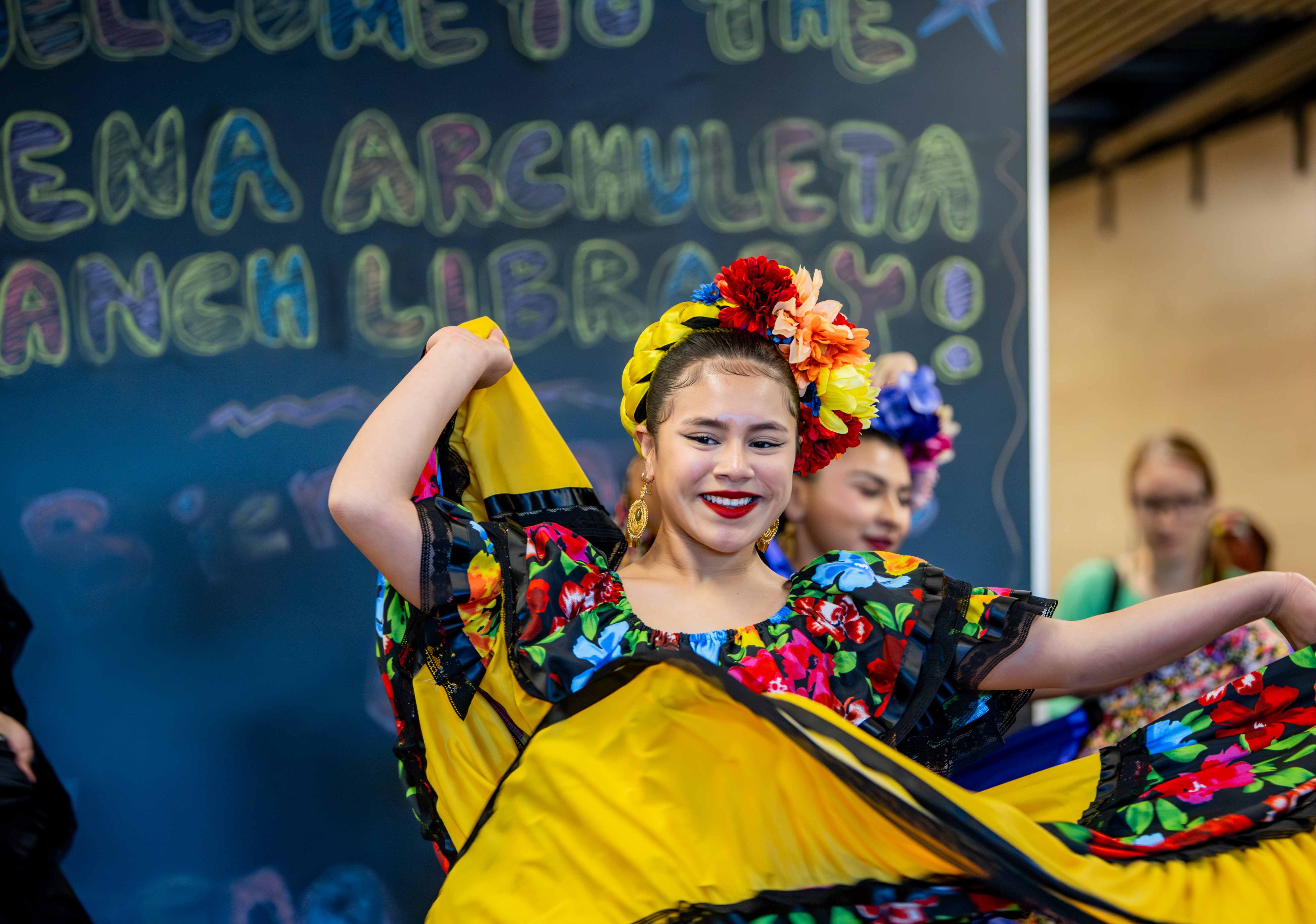 A young folklorico dancer performs inside the Lena Archuleta Branch Library