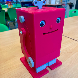 3D printed pink robot with googly eyes, the object opens up to hold items for storage