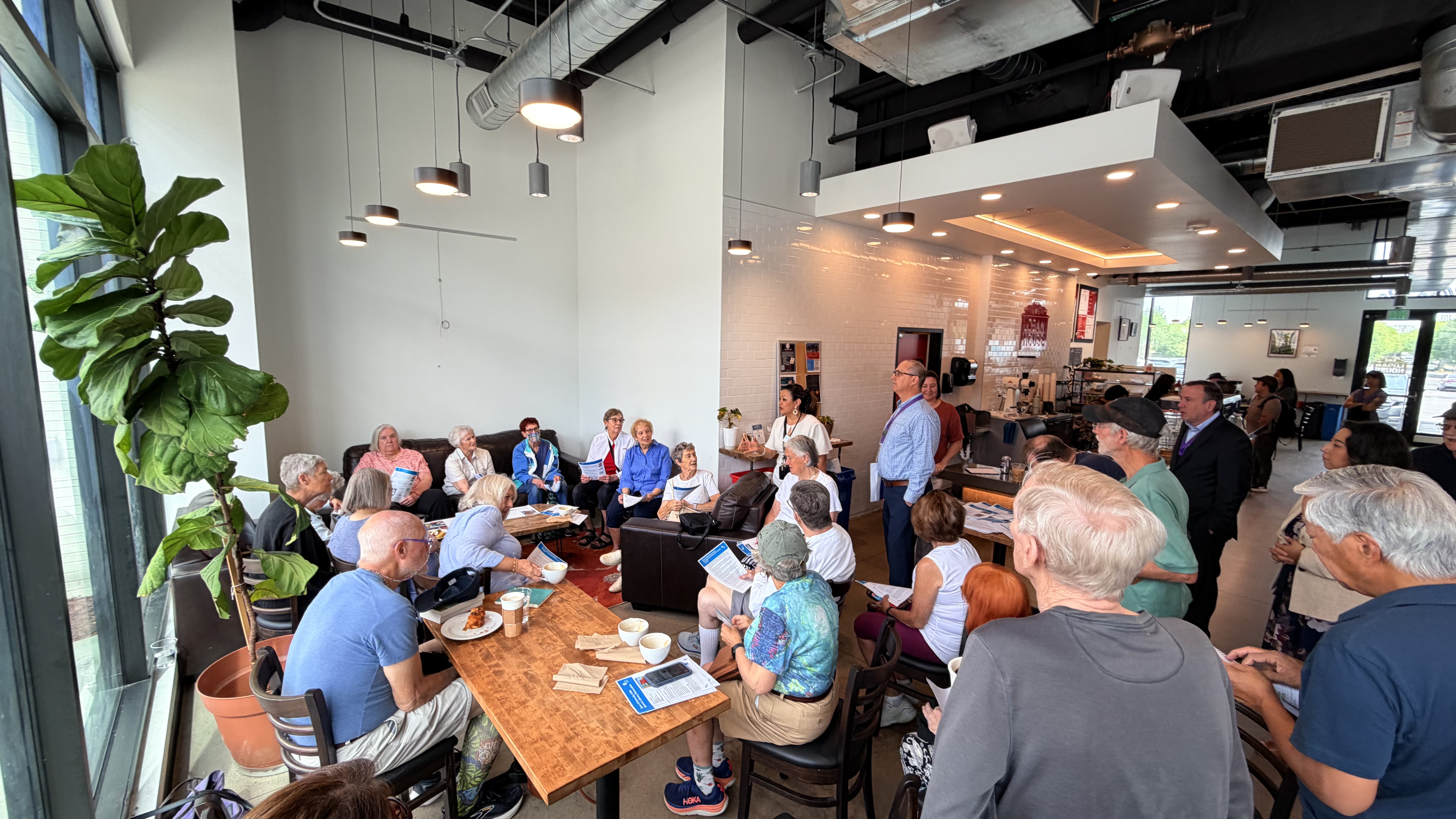 Photograph of community conversation at a coffee shop about the DPL branch renovations.