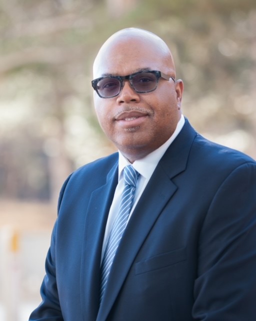 Portrait photograph of Library Commissioner Cedric Buchanon