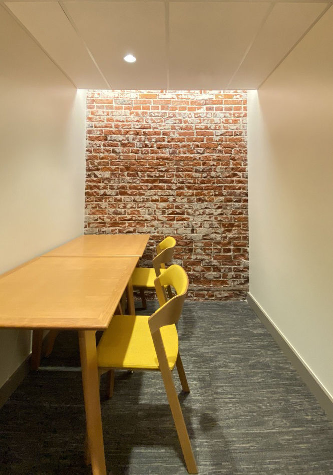 Brick wall lined newly renovated study space 