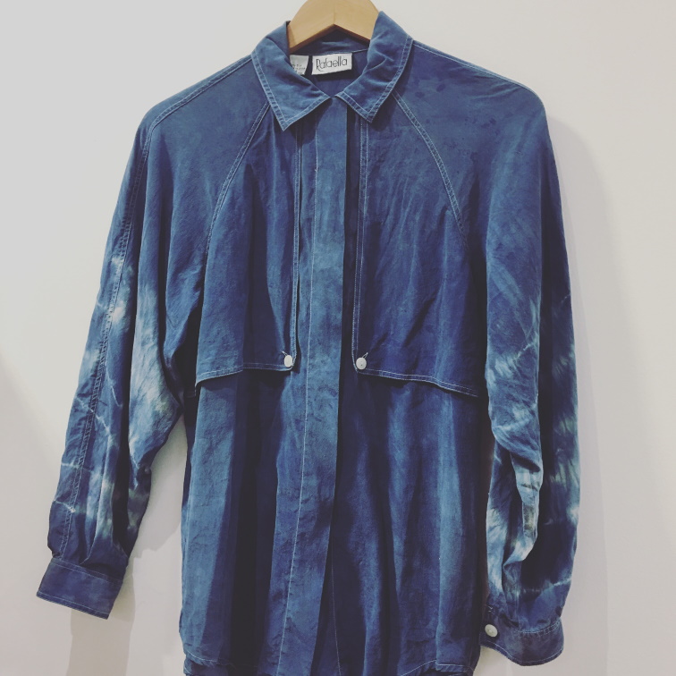 Image of a long-sleeved button-up shirt, dyed with indigo.