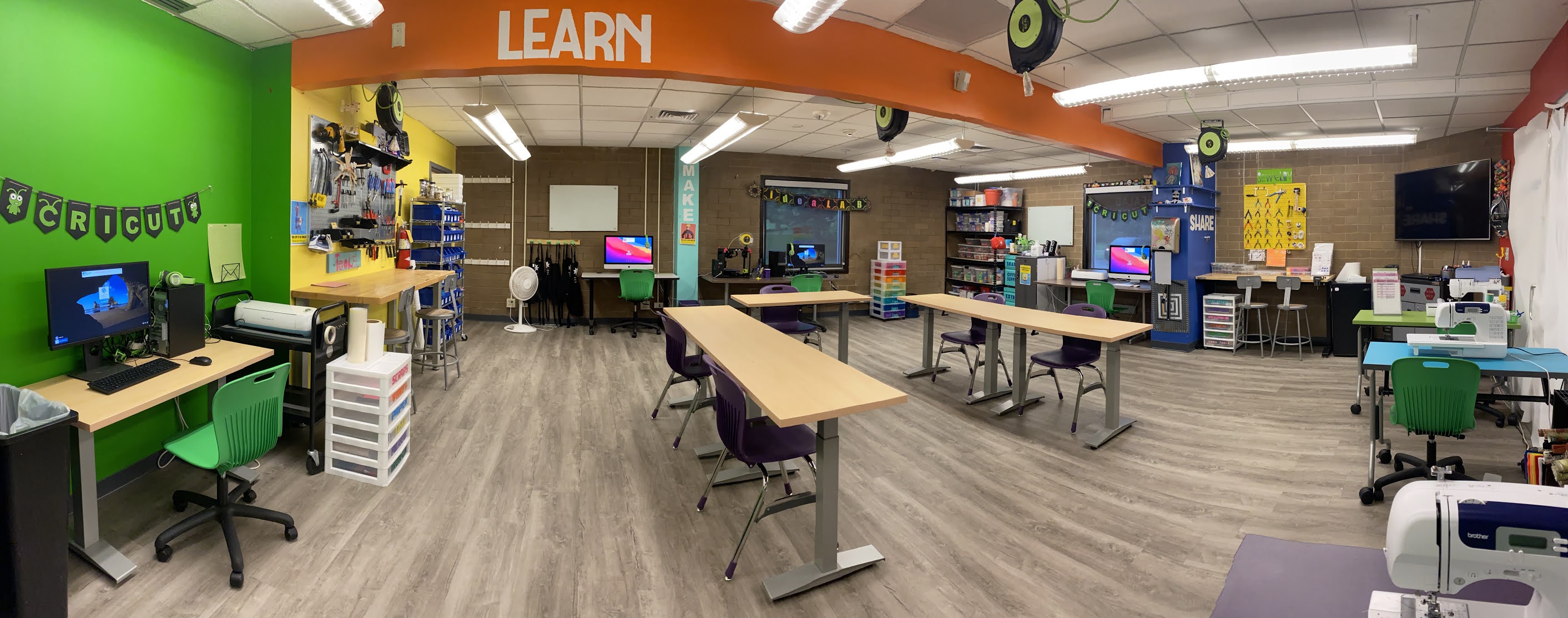 Interior photo of the Montbello Branch Library ideaLAB, showing computers, tools, and communal workspaces.