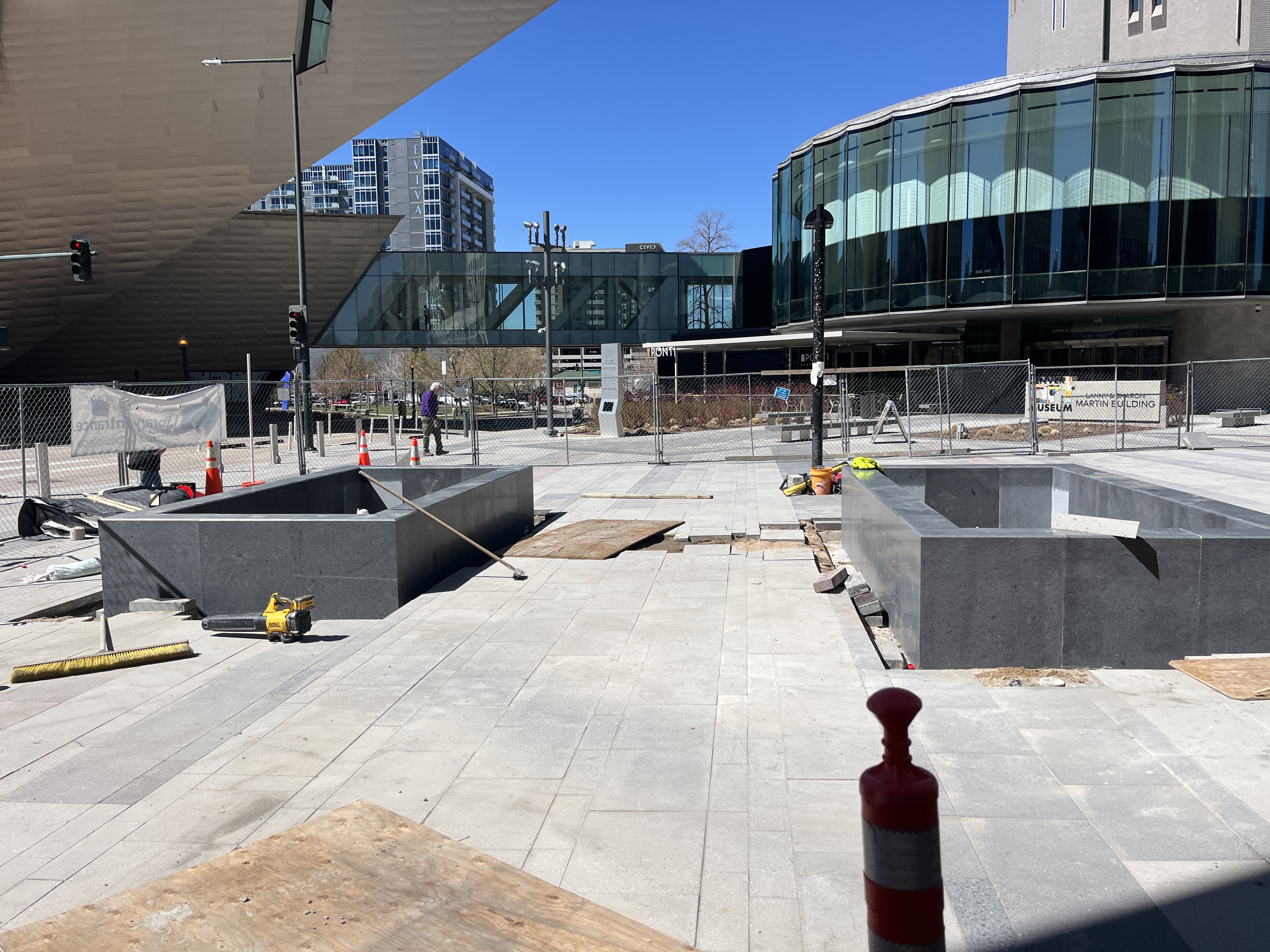 Photo of two granite planters with construction tools surrounding them.