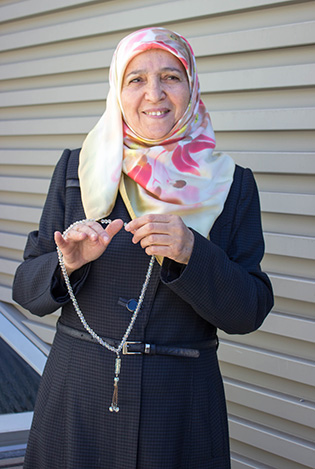 Photograph of a woman holding a rosary