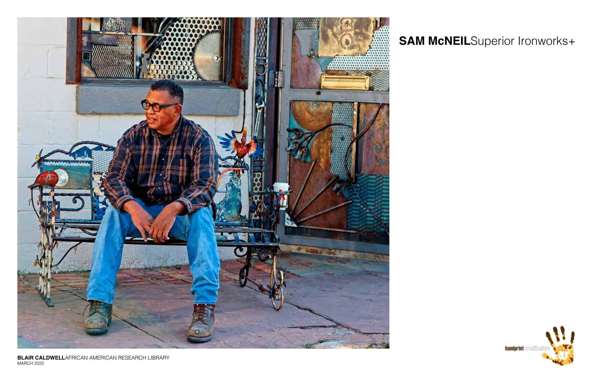 Photograph of artist Sam McNeil sitting on stairs on exterior of brick building.