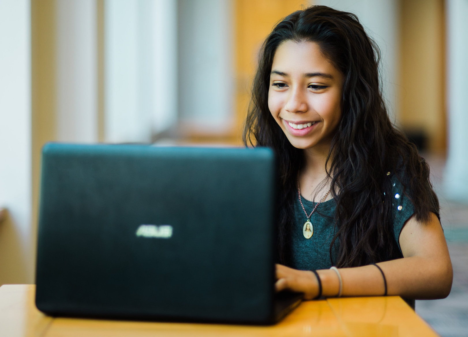 Young girl on a laptop in the library