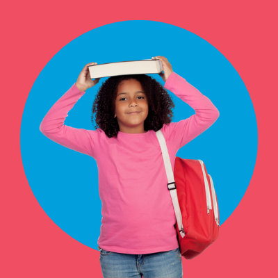 Child with backpack holding a book above their head with both hands