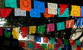 Colorful flags made from cut paper strung across the ceiling