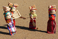 Four worry dolls in colorful outfits