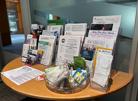 Brochures and products neatly displayed on a wooden table inside the Community Resources office