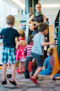 kids jump and sing along with tunes during Storytime at the Central Library