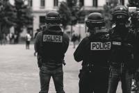Photo by ev on Unsplash, black and white photo of police officers in riot gear