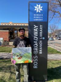 Mike Graves holding his work 'Very Hungry Caterpillar' outside the Ross-Broadway Branch Library