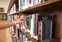 image: reaching book on shelf