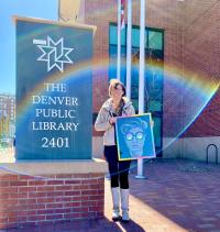 Julia Williams holds a piece of her artwork outside the Blair-Caldwell African American Research Library