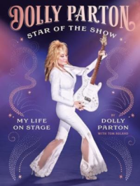 dolly parton in sparkly white outfit with a guitar