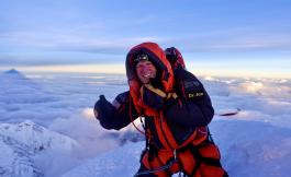 Jon Kedrowski in a heavy coat on top of a snowy peak