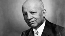 A black and white portrait of Carter G. Woodson