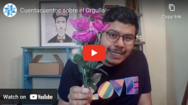 Screenshot of a video that shows a person wearing a pride shirt holding out flowers