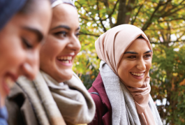 Three women walking and smiling