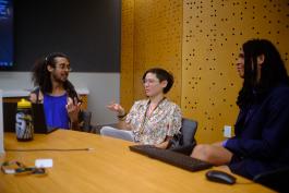Photo of library staffing planning and discussing in a Central Library meeting room.