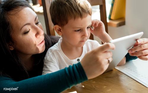 Woman reads to child from tablet