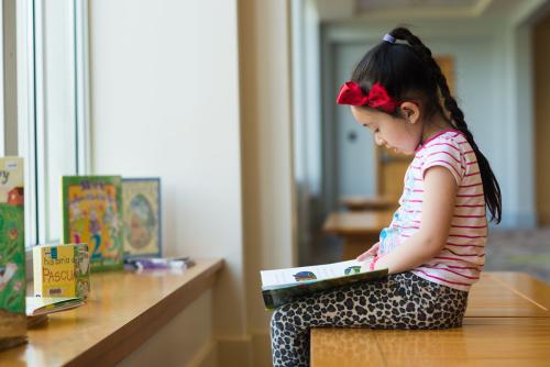 Girl reading on bench
