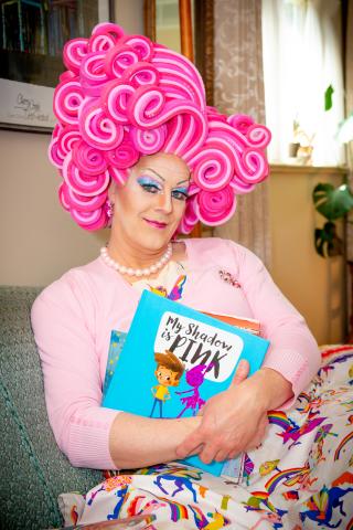 Shirley Delta Blow in pink hair holding a book