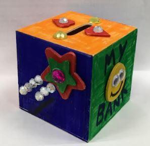 Wooden bank decorated by a child using paint, stickers and gems.