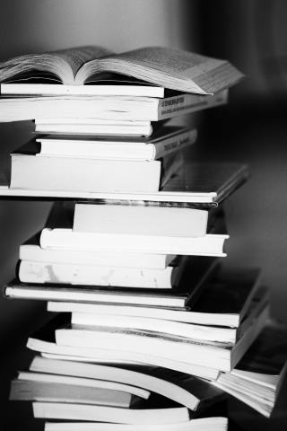 Black and white photo of a stack of books.