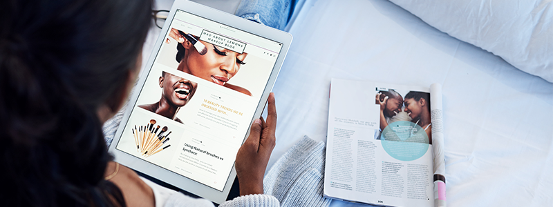 High angle shot of an unrecognizable woman using a tablet reading an e-magazine