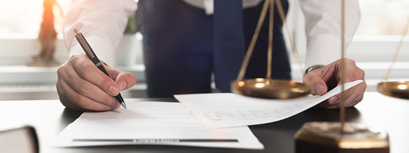 Lawyer signing legal documents