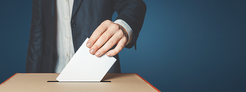 Man Voter Putting Ballot Into Voting box